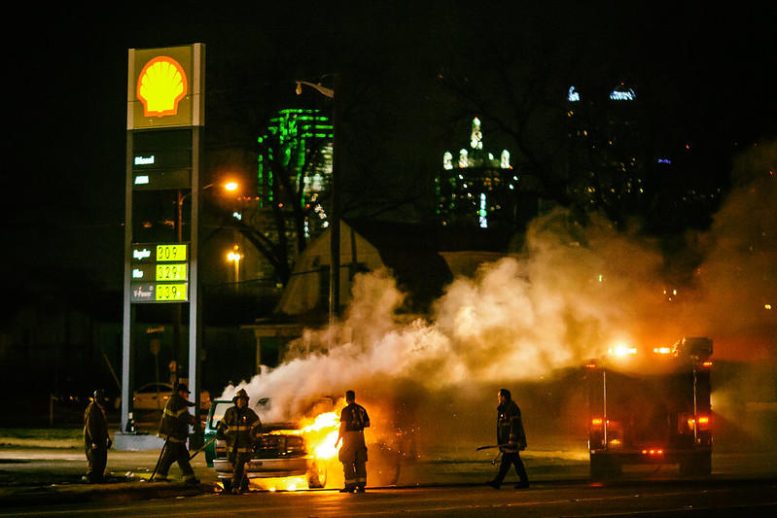 Firefighters Extinguishing Flames at a Gas Station