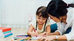 Little Kid Drawing With Teacher