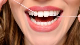 Woman Flossing Teeth