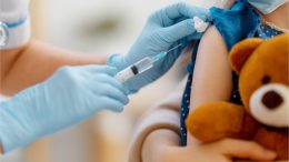 Young Child Holding Stuffed Animal Vaccine Shot